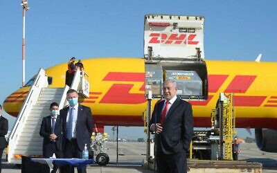Prime Minister Benjamin Netanyahu attends the arrival of a DHL freight plane transporting the first batch of Pfizer vaccines at Ben Gurion Airport on December 9, 2020. (Marc Israel Sellem/POOL)