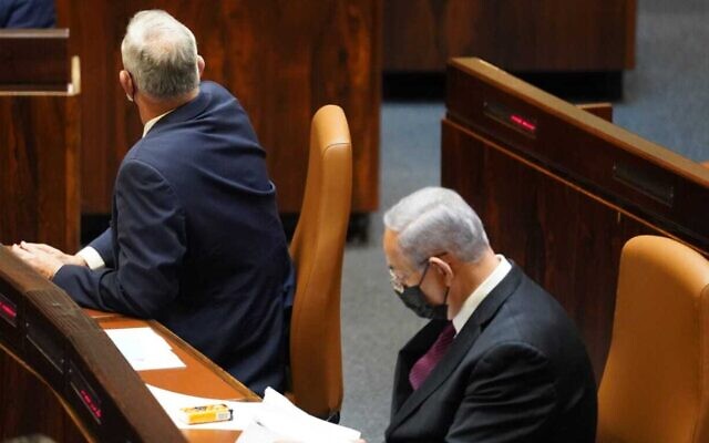 Blue and White leader Benny Gantz (left) is seen with his back to Prime Minister Benjamin Netanyahu as the Knesset approves a preliminary reading of a bill to dissolve parliament, December 2, 2020 (Danny Shem-Tov / Knesset spokesperson's office)