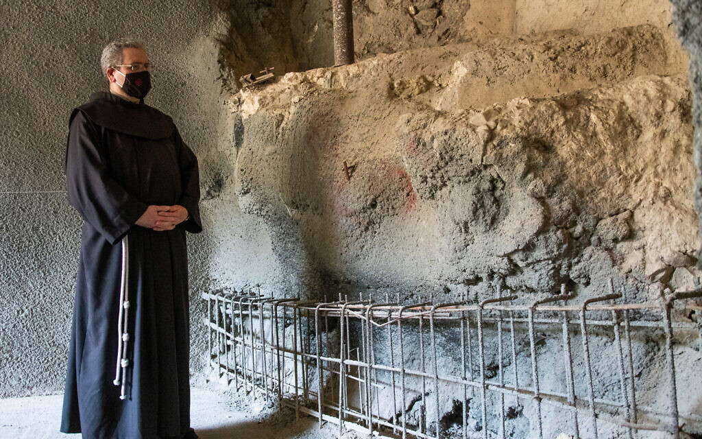 Fr. Francesco Patton, Custos of the Holy Land, next to the ancient ritual bath. (Yoli Schwartz/ Israel Antiquities Authority)