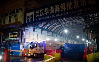 This file photo taken on January 11, 2020 shows members of staff of the Wuhan Hygiene Emergency Response Team leaving the closed Huanan Seafood Wholesale Market in the city of Wuhan, in Hubei, Province (NOEL CELIS / AFP)
