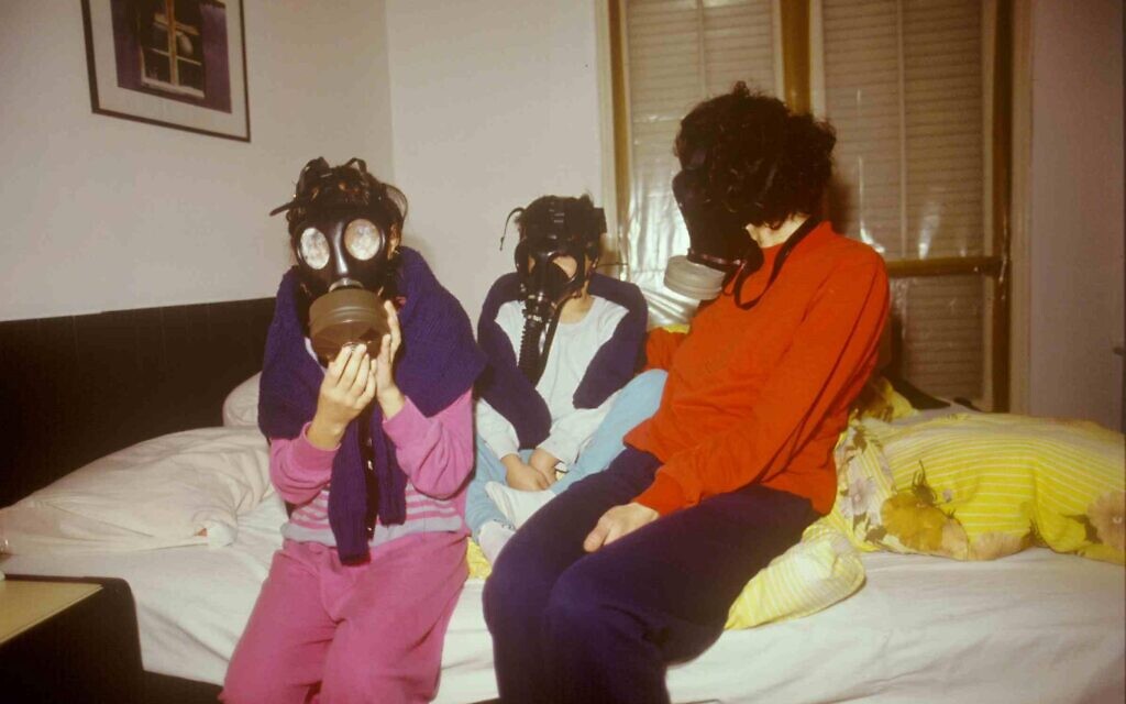 An Israeli family wears gas masks for fear of a chemical weapon attack during the 1991 Gulf War. (Michael Tzarfati/Defense Ministry Archive)