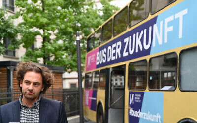 Shai Hoffman explains about his Bus of Encounters project in Frankfurt, Germany on August 25, 2020. (Cnaan Liphshiz/ JTA)