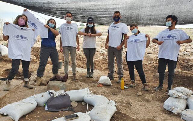 Students from the Hanaton pre-military preparatory program work on the excavation of an Islamic period building in which a late 5th century CE Greek inscription, 'Christ born of Mary,' was found in secondary use, in the village of et-Taiyiba (Taybeh) in the Jezreel Valley. (Einat Ambar-Armon/Israel Antiquities Authority)