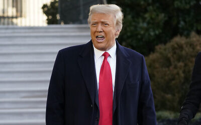 Then-US president Donald Trump speaks with reporters as he walks to board Marine One on the South Lawn of the White House, January 20, 2021, in Washington. (AP Photo/Alex Brandon)