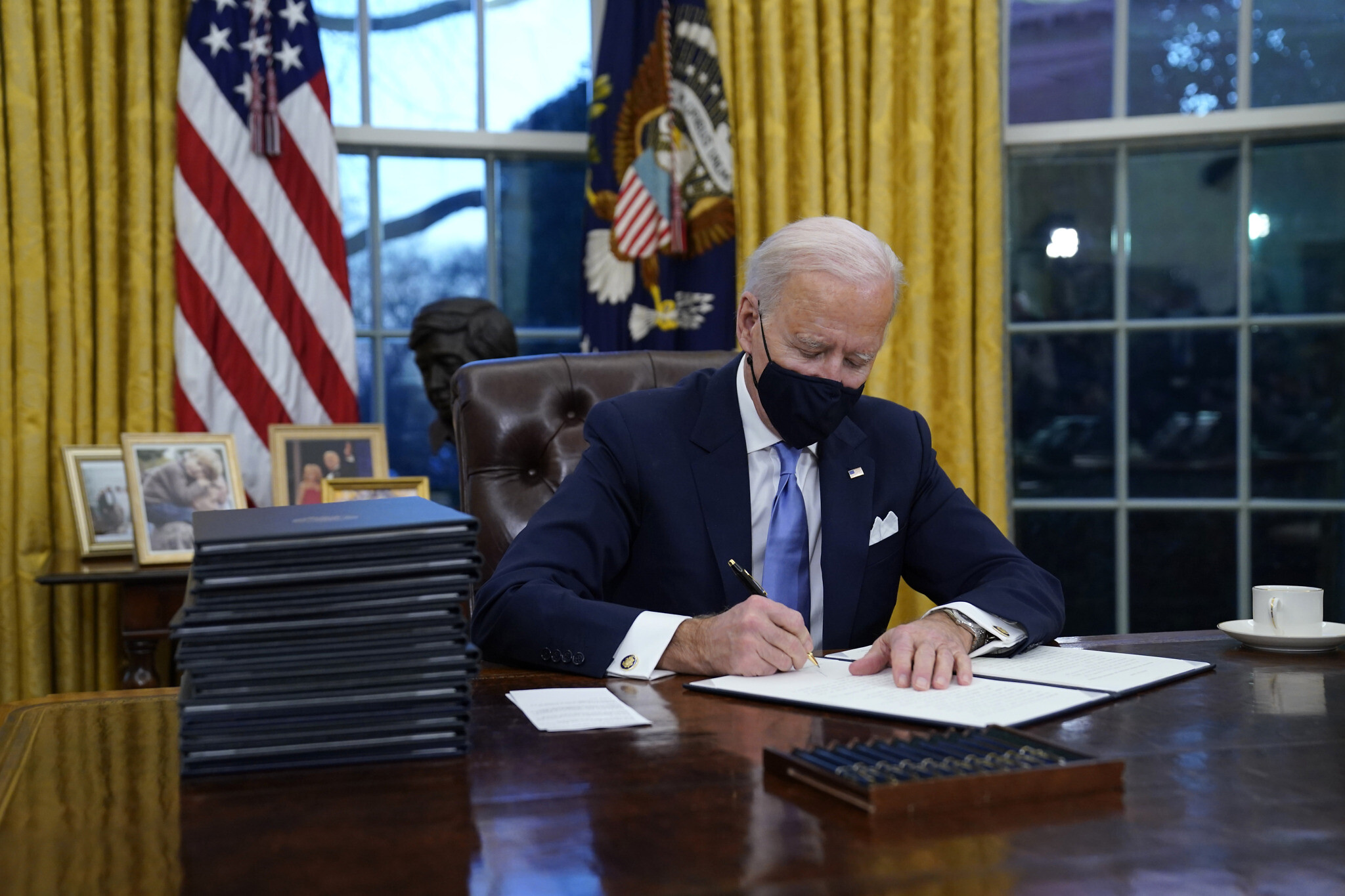 With 15 strokes of a pen, Biden reverses Trump on climate, virus and  immigration | The Times of Israel