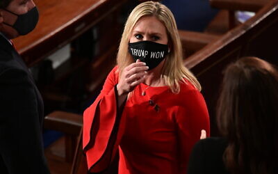 In this Sunday, January 3, 2021, file photo, Rep. Marjorie Taylor Greene, R-Ga., wears a 'Trump Won' face mask as she arrives on the floor of the House to take her oath of office on opening day of the 117th Congress at the US Capitol in Washington. (Erin Scott/Pool Photo via AP)