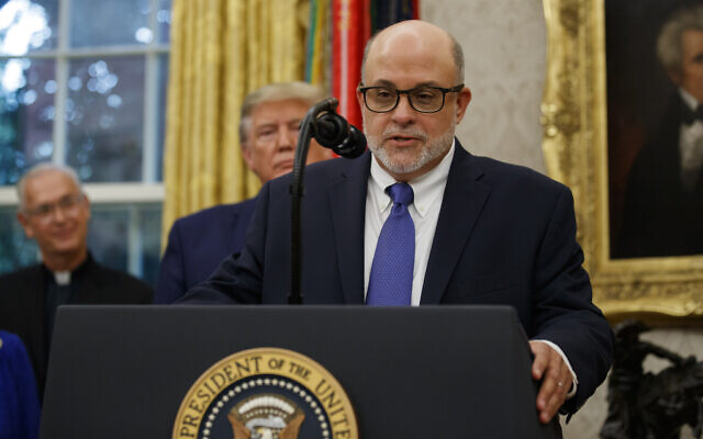 Mark Levin speaks, with US President Donald Trump behind him in the Oval Office of the White House, Oct. 8, 2019, in Washington. (AP Photo/Alex Brandon)