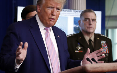 US President Donald Trump speaks in the James Brady Press Briefing Room of the White House, April 1, 2020, in Washington, as Chairman of the Joint Chiefs Gen. Mark Milley listens. (AP Photo/Alex Brandon)