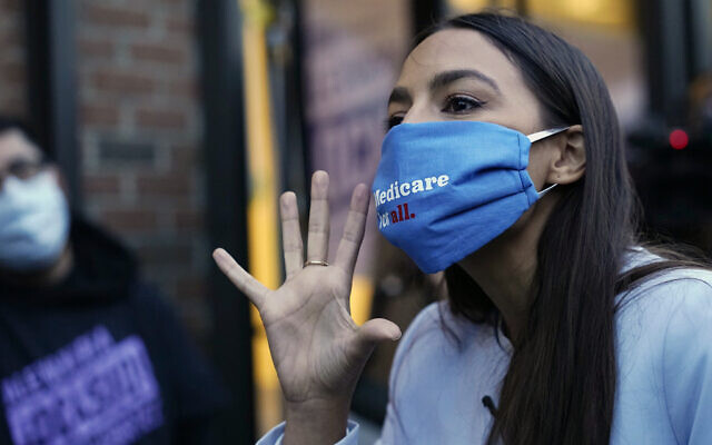 U.S. Rep. Alexandria Ocasio-Cortez, D-N.Y., speaks to members of her staff and volunteers who helped get out the vote and with her campaign, Tuesday, Nov. 3, 2020, outside her office in the Bronx borough of New York. (AP Photo/Kathy Willens)
