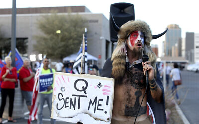 A Qanon believer Jacob Chansley, who was later arrested for his role storming the Capitol, speaks to a crowd of President Donald Trump supporters outside of the Maricopa County Recorder's Office where votes in the general election are being counted, in Phoenix, Thursday, Nov. 5, 2020. (AP Photo/Dario Lopez-MIlls)