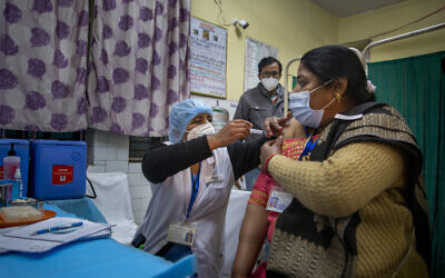 A health worker engages in a COVID-19 vaccine delivery system trial in New Delhi, India, Jan. 2, 2021 (AP Photo/Altaf Qadri)