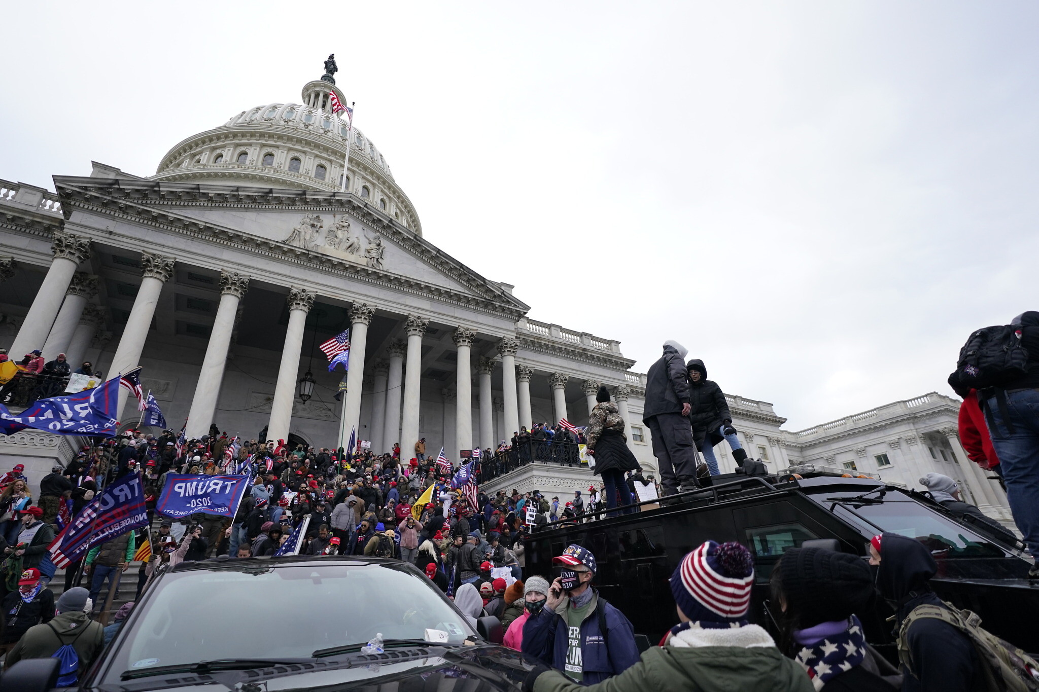 Trump supporters stand on top of a police vehicle, Wednesday, Jan. 6, 2021, at the Capitol in Washington. (AP Photo/Julio Cortez)