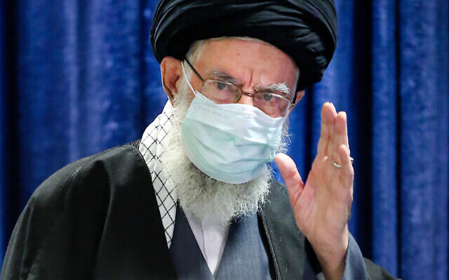 In this picture released by an official website of the office of the Iranian supreme leader, Supreme Leader Ayatollah Ali Khamenei waves before he addresses the nation in a televised speech in Tehran, Iran, Friday, Jan. 8, 2021. in Tehran, Iran. Khamenei called to ban the import of American and British vaccines, claiming they are not to be trusted. (Office of the Iranian Supreme Leader via AP)