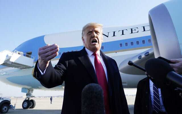 US President Donald Trump speaks to the media before boarding Air Force One, at Andrews Air Force Base, Maryland, January 12, 2021. (AP Photo/Alex Brandon)