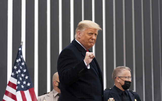 Then-US President Donald Trump pumps his fist as he tours a section of the US-Mexico border wall in Alamo, Texas, January 12, 2021. (AP Photo/Alex Brandon)