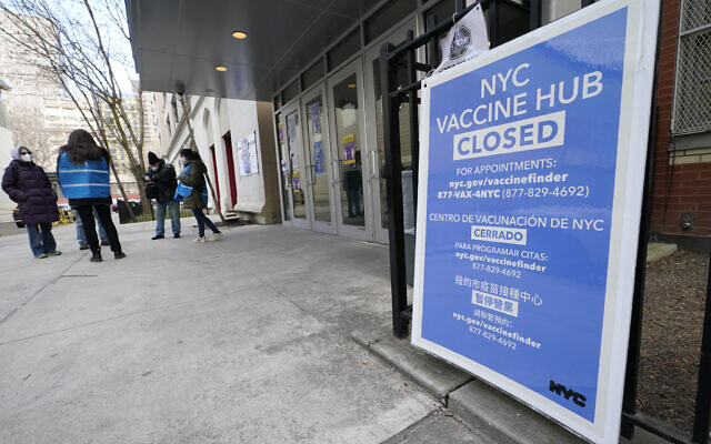 People who had appointments to get COVID-19 vaccinations talk to New York City health care workers, Jan. 21, 2021, outside a closed vaccine hub in the Brooklyn borough of New York after they were told to come back in a week due to a shortage of vaccines (AP Photo/Kathy Willens)