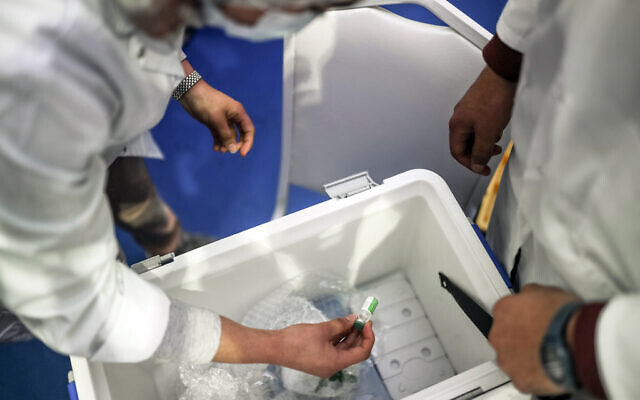A health worker prepares doses of the AstraZeneca-Oxford COVID-19 vaccine on the first day of vaccination campaign, in Rabat, Morocco, Jan. 29, 2021 (AP Photo/Mosa'ab Elshamy)
