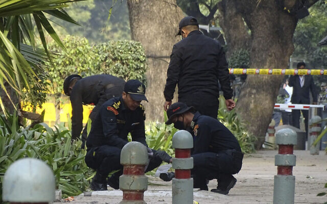 National Security Guard soldiers inspect the site of a blast near the Israeli Embassy in New Delhi, India, Jan. 30, 2021 (AP Photo/Dinesh Joshi)