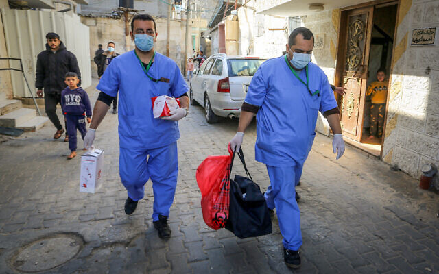 The Palestinian Authority Ministry of Health crews conduct random checks through blood in the town of Rafah, southern Gaza Strip, on January 14, 2021. (Abed Rahim Khatib/Flash90)