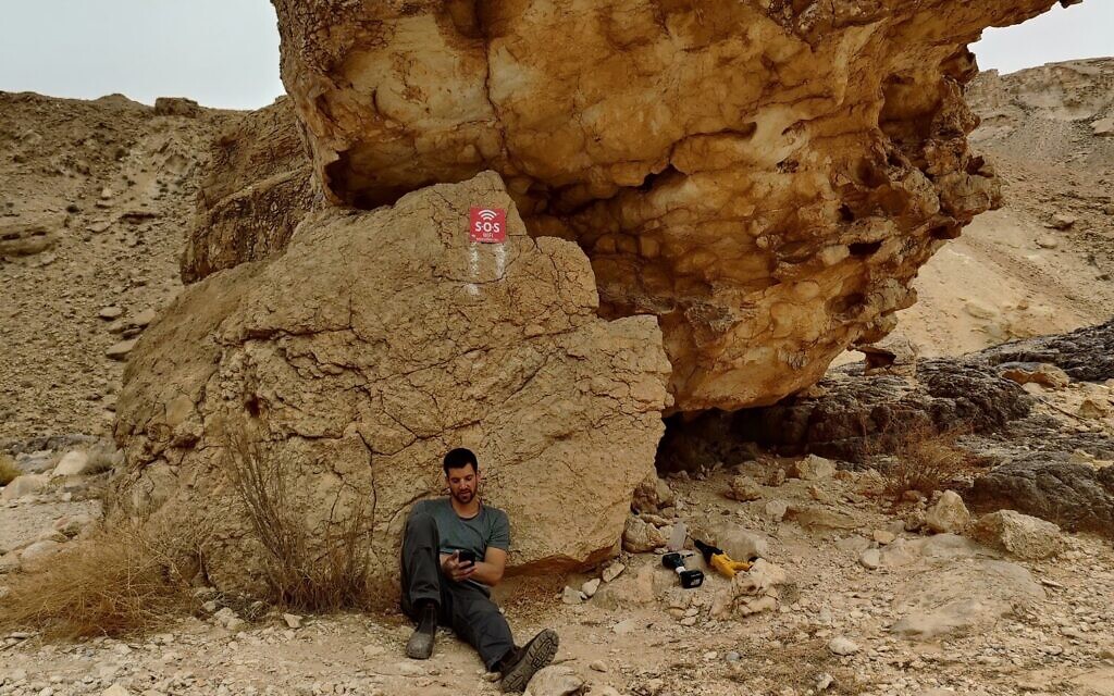 A worker installing an SOS WiFi router in the Hawwa stream hiking trail in southern Israel. (Courtesy)