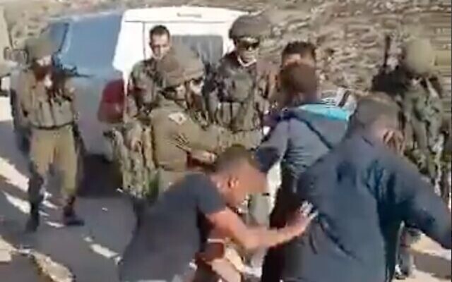 Palestinians scuffle with Israeli soldiers outside of al-Tuwani, southeast of Yatta, in the South Hebron Hills in the West Bank, on January 1, 2021. (Screenshot)