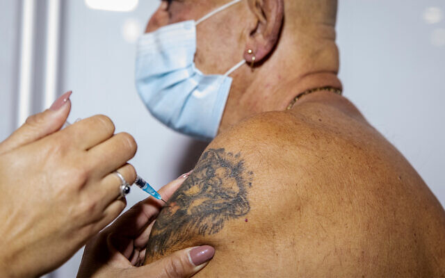 Illustrative: A COVID-19 vaccine is administered in Jerusalem, January 4, 2021. (Olivier Fitoussi/Flash90)