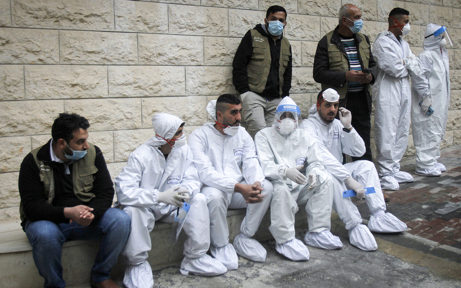 Palestinians sit as PA Prime Minister Mohammed Shtayyeh opens a hospital for COVID-19 in the West Bank city of Nablus, on January 16, 2021. (Nasser Ishtayeh/ Flash90)