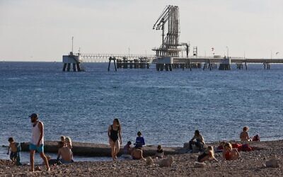 Israelis at a Red Sea beach close to the Europe Asia Pipeline Company's oil terminal in Eilat, southern Israel, February 10, 2021. (Menaham Kahana/AFP)