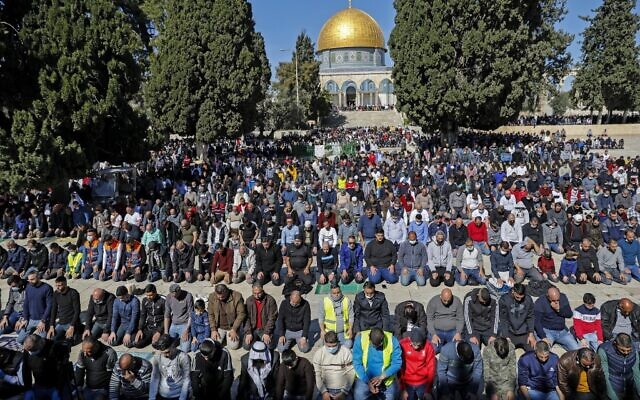 Palestinian Muslims resume praying outside the Dome of the Rock Mosque in Jerusalem's al-Aqsa mosques compound on February 12, 2021, following a 45-day pause due to COVID-19 restrictions. (AHMAD GHARABLI / AFP)