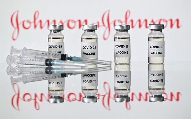 Vials with COVID-19 vaccine stickers attached and syringes with the logo of US pharmaceutical company Johnson & Johnson, November 17, 2020. (Justin Tallis/AFP)