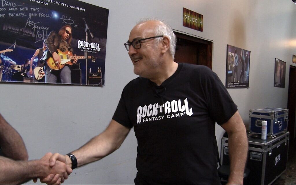 David Fishof, Rock ‘N’ Roll Fantasy Camp founder and owner greeting a camper during a Rock Camp in 2018. (Courtesy Rock N' Roll Fantasy Camp)