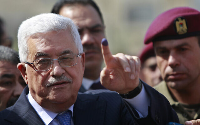 In this October 20, 2012, photo, Palestinian Authority President Mahmoud Abbas shows his ink-stained finger after casting his vote during local elections at a polling station in the West Bank city of Ramallah. (AP/Majdi Mohammed)