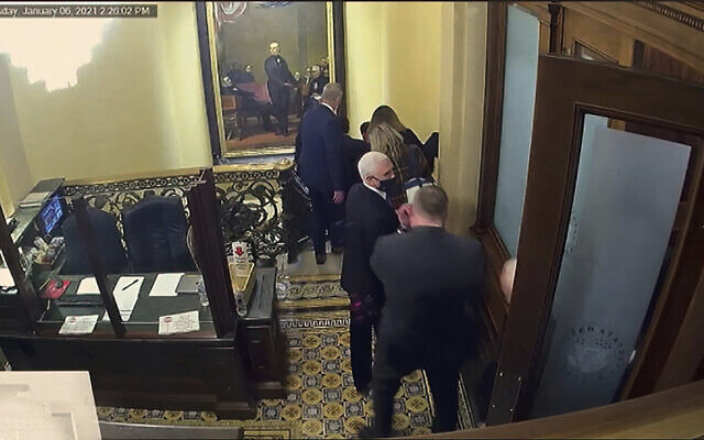 In this image from video, a security video shows Vice President Mike Pence being evacuated as rioters breach the Capitol, as House impeachment manager Del. Stacey Plaskett, D-Virgin Islands, speaks during the second impeachment trial of former President Donald Trump in the Senate at the U.S. Capitol in Washington, Wednesday, Feb. 10, 2021. (Senate Television via AP)