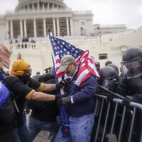 Rioters try to break through a police barrier at the Capitol in Washington, January 6, 2021. (AP Photo/John Minchillo, File)