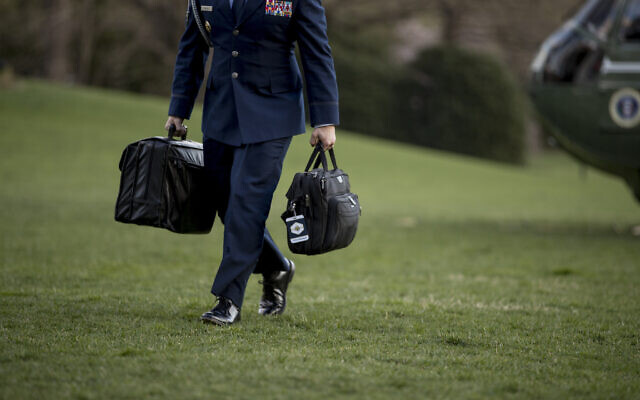 Illustrative -- A US military aide carries the 'president's emergency satchel,' also know as 'the football,' with the nuclear launch codes, across the South Lawn of the White House in Washington, March 31, 2019 (AP/Andrew Harnik)