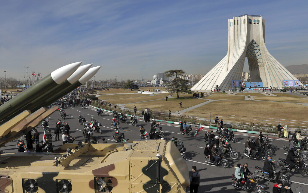 Iranians drive past missiles on motorcycles during a rally marking the 42nd anniversary of the Islamic Revolution, at Azadi (Freedom) Square in Tehran, Iran, Wednesday, February 10, 2021. (AP/Ebrahim Noroozi)