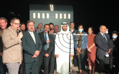 Rabbi Elie Abadie (yellow tie) joins the Jewish community in the UAE for a Hanukkah celebration (photo credit: Courtesy)