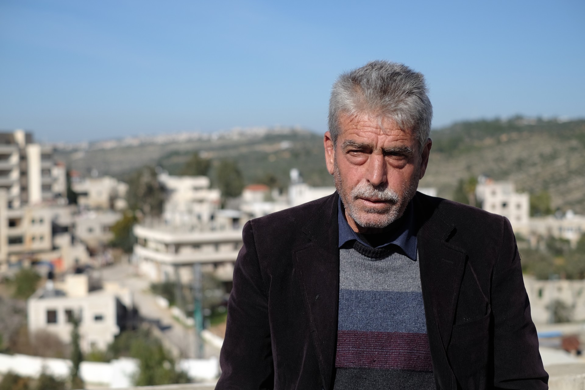 The father of Khaled Nofal, who was killed in an altercation with Israeli settlers, on top of the family home in the West Bank village of Ras Karkar on February 11, 2021. (Judah Ari Gross/Times of Israel)