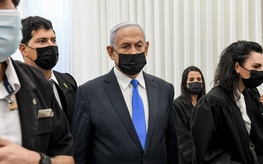 Prime Minister Benjamin Netanyahu arrives for a court hearing at the District Court in Jerusalem on February 8, 2021. Netanyahu is charged with fraud and breach of trust in three cases and bribery in one of them. (Reuven Kastro/POOL)