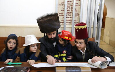 Ultra-Orthodox Jews read Megillat Esther during the Jewish holiday of Purim, in the northern town of Meron, on February 25, 2021. (David Cohen/Flash90)