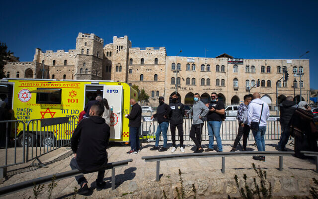 East Jerusalemites receive COVID-19 vaccine injections at the Damascus Gate in Jerusalem Old City on February 26, 2021. (Olivier Fitoussi/Flash90)