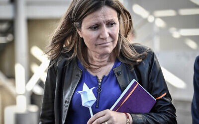 President of the Laws Commision at the French National Assembly Yael Braun-Pivet holds a paper flower offered by a man at the 'Centre de Retention Administrative' (CRA), a migrant detention center in Vincennes, eastern Paris, on September 18, 2019. (STEPHANE DE SAKUTIN/AFP via Getty Images)