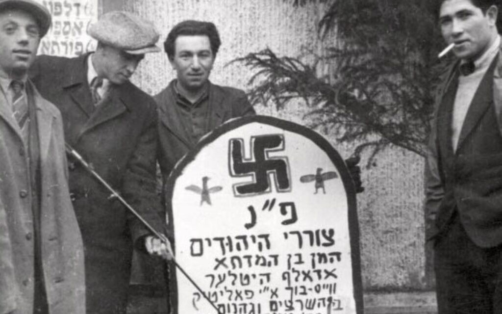 Purim with Holocaust survivors at the Landsberg DP camp in Germany, with a mock-tombstone for Haman and Hitler (Yad Vashem)