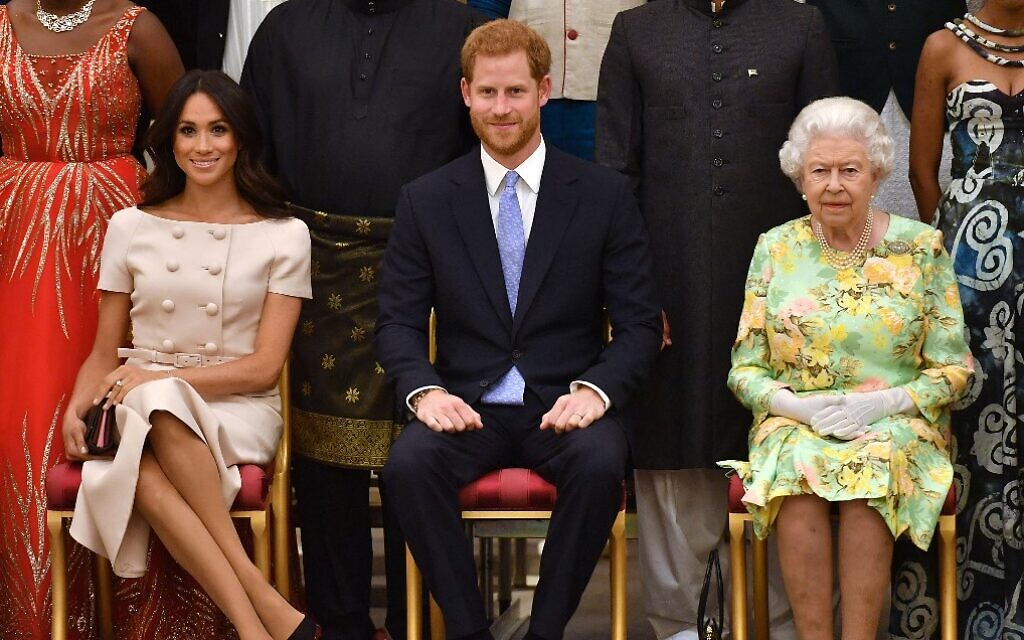 Left to right: Meghan Markle, Prince Harry, and Britain's Queen Elizabeth II pose for a picture during the Queen's Young Leaders Awards Ceremony, at Buckingham Palace in London, June 26, 2018. (John Stillwell/Pool/AFP/File)