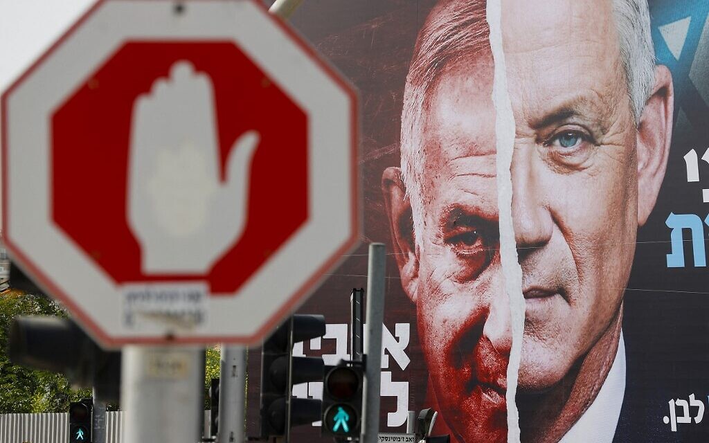An election campaign billboard for Israel's Blue and White opposition party led by Benny Gantz (R) depicting him and Israeli Prime Minister Benjamin Netanyahu of the Likud party, hangs in the city of Bnei Brak, on March 14, 2021, ahead of the March 23 general election. The writing in Hebrew reads "Benny to the Knesset or Bibi forever". (JACK GUEZ / AFP)