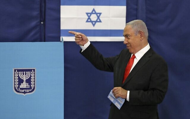 Benjamin Netanyahu gestures as he votes at a polling station in Jerusalem on March 23, 2021, in the fourth national election in two years. (RONEN ZVULUN / POOL / AFP)