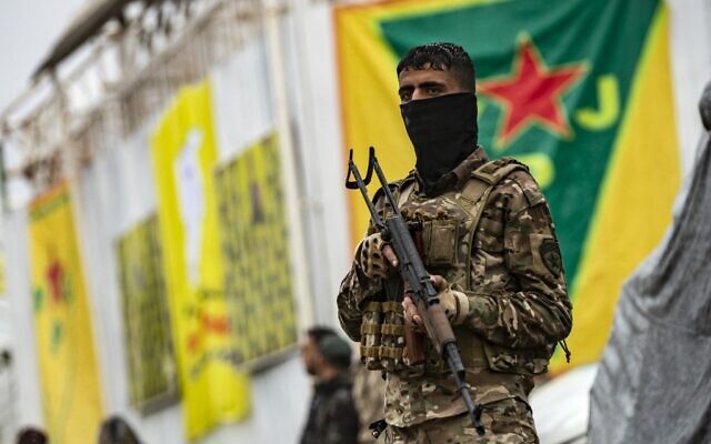 Fighters of the Kurdish-led Syrian Democratic Forces (SDF) take part in a military parade in the US-protected Al-Omar oil field in the eastern province of Deir Ezzor on March 23, 2021, marking the second annual anniversary of Baghouz's liberation from the Islamic State (IS) group. (Delil SOULEIMAN / AFP)
