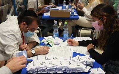 Election workers count ballots in Jerusalem on March 25, 2021. (Emmanuel Dunand/AFP)