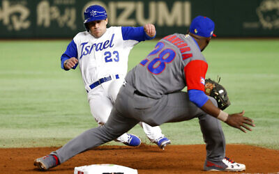 Illustrative: Israel's Sam Fuld (23) slides back to first safely as Cuba's first baseman William Saavedra prepares to tag in the seventh inning of their second round game of the World Baseball Classic at Tokyo Dome in Tokyo, March 12, 2017. (AP Photo/Shizuo Kambayashi)