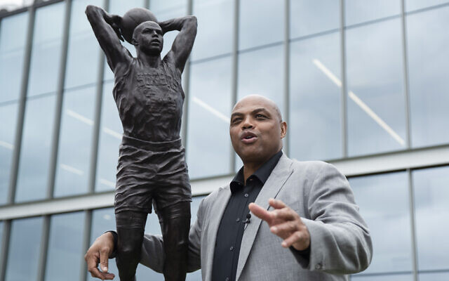 Charles Barkley poses for photographs with a sculpture honoring him at the Philadelphia 76ers NBA basketball training facility in Camden, New Jersey, September 13, 2019. (AP Photo/Matt Rourke)